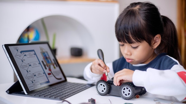 Asia students learn at home in coding robot cars and electronic board cables in STEM STEAM mathematics engineering science technology computer code in robotics for kids concept