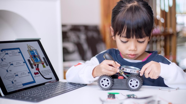 Asia students learn at home in coding robot cars and electronic board cables in STEM STEAM mathematics engineering science technology computer code in robotics for kids concept