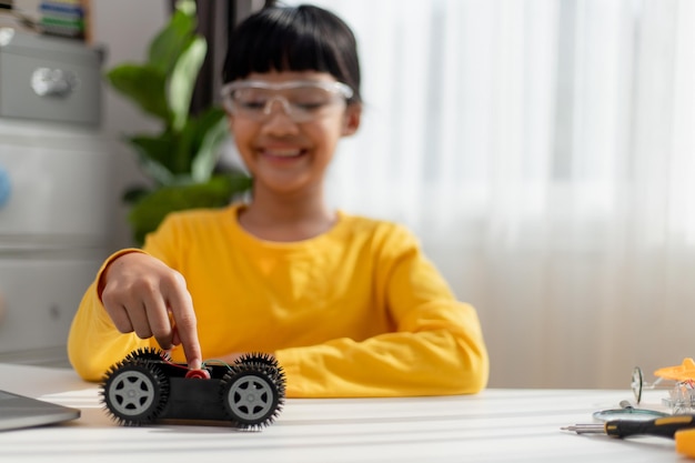 Asia students learn at home in coding robot cars and electronic board cables in STEM STEAM mathematics engineering science technology computer code in robotics for kids concept