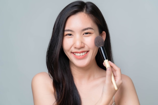 Asia woman applying hyaluronic serum on her face with pipette