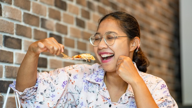 Asia Woman holding Fresh Homemade Italian Pizza Margherita and Smiling Slice of hot pizza large