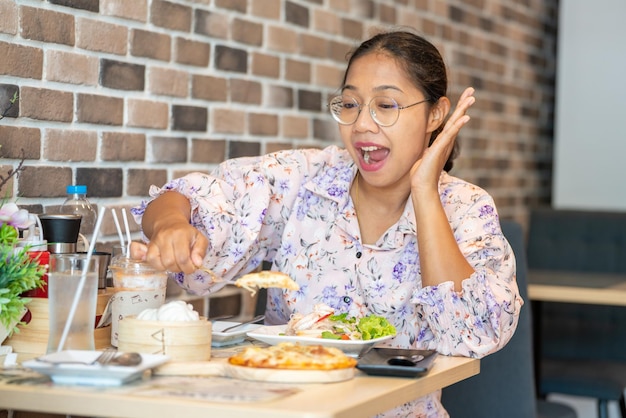 Asia Woman holding Fresh Homemade Italian Pizza Margherita and Smiling Slice of hot pizza large