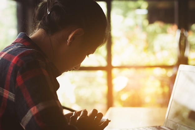 Asia woman,student using mobile phone, computer working with intention, happy