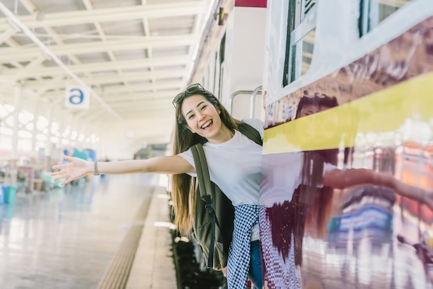 Asia woman Traveller feeling happiness before go to travel at the train station