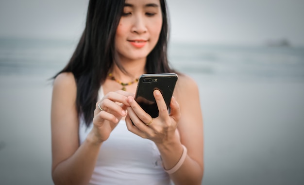 Asia woman using mobile phone for checking social media