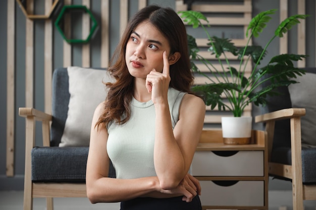 Asia young woman thinking at home