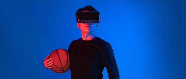 Photo asian athlete with vr holding basketball player on virtual space contrivance