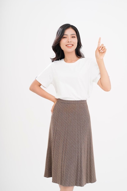 Asian attractive beautiful young woman with hand gesture showing with finger on the copy space isolated on background