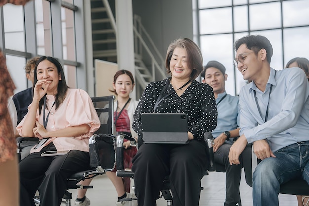 Asian audience people happy and laughing in a business conference at hall