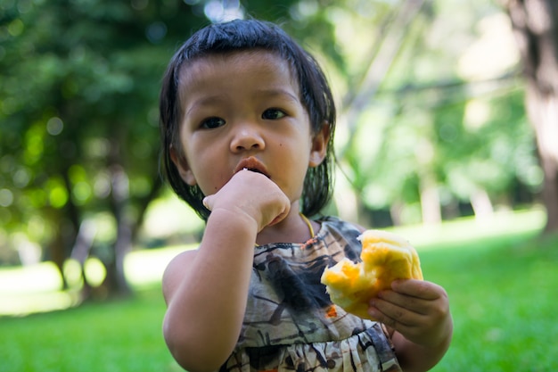 Asian baby girl playing in garden