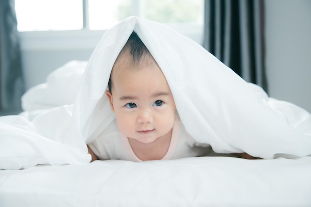 Asian baby lying on bed with soft blanket indoors cute little asian newborn baby