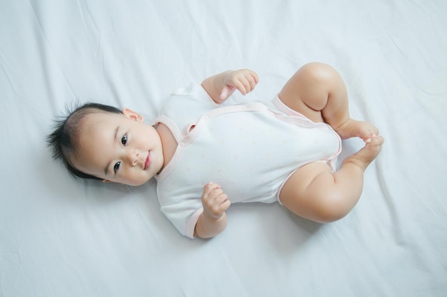 Asian baby lying on bed with soft blanket indoors cute little asian newborn baby