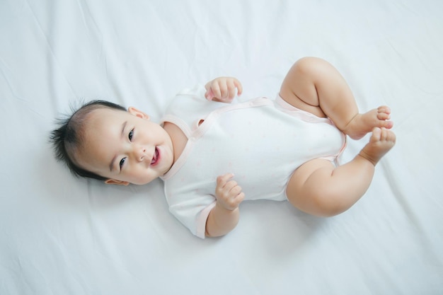 Asian baby lying on bed with soft blanket indoors cute little asian newborn baby