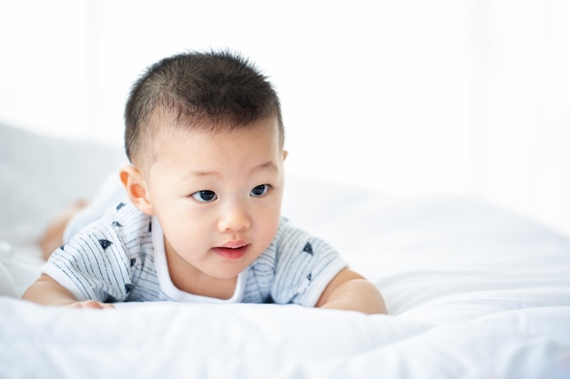 Asian baby portrait happy and look to camera in room.