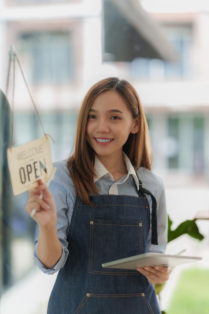 Asian Barista cafe owner smile while cafe open SME entrepreneur seller business concept