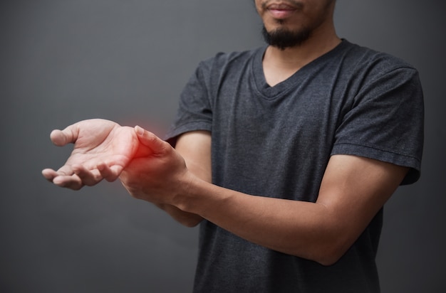 Asian beard man having wrist pain.