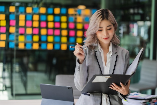 Asian beautiful businesswoman seriously working thinking idea for work on computer and think project for idea sitting work indoor