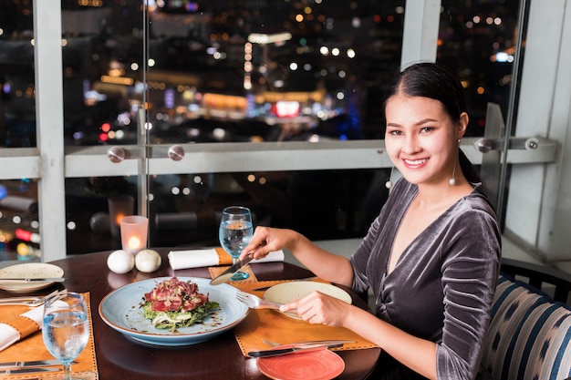 Asian Beautiful Woman have Dinner in luxury roof top restaurant 