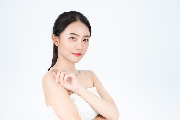 Asian beautiful woman in white undershirt shows bright and healthy skin.