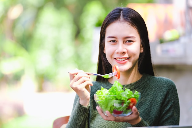 Asian beautiful young girl eating salad vegetable