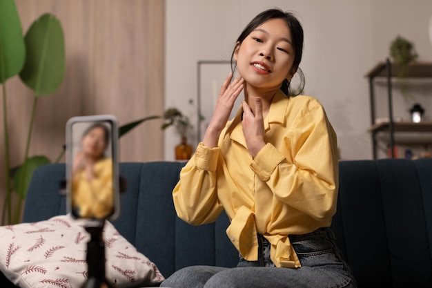 Asian Beauty Blogger Woman Making Facial Massage Creating Video Indoor