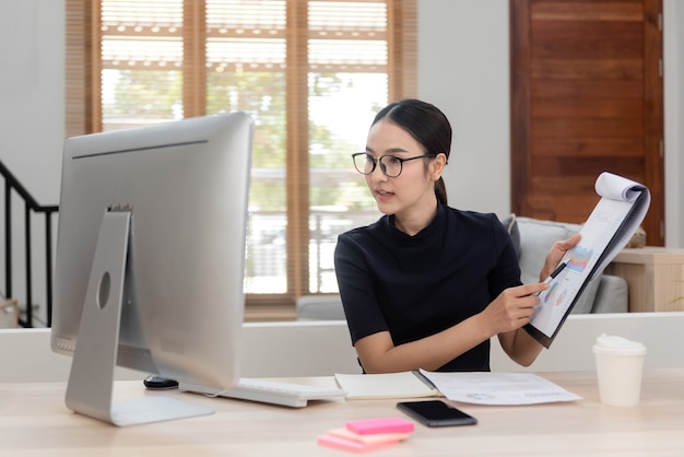 Asian beauty Work from home via computer Interacting with colleagues With a happy smiling face, a new normal online activity