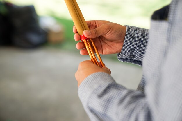 Asian believing, pray with incense and foods.