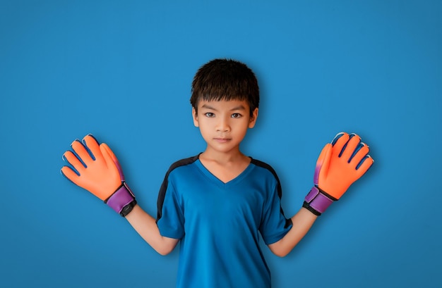 Asian boy is a football goalkeeper wearing gloves spreading his hand isolated on white