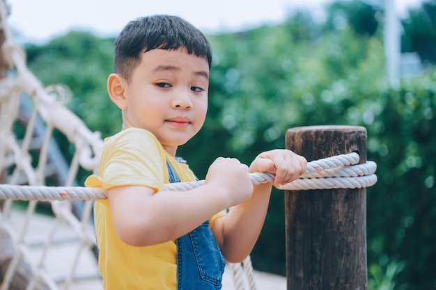 Asian boy playing in playground