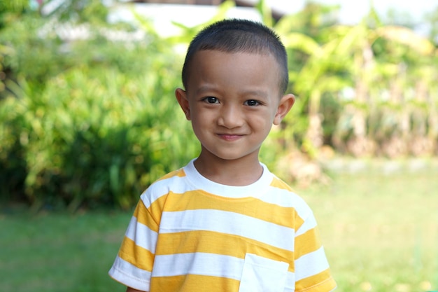 Asian boy smiling happily in the garden