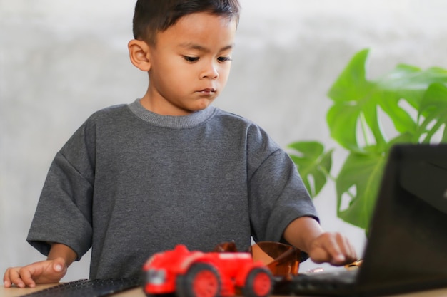 Asian boy students learn at home in coding robot cars and electronic board cables in STEM STEAM mathematics engineering science technology computer code in robotics for kids concept