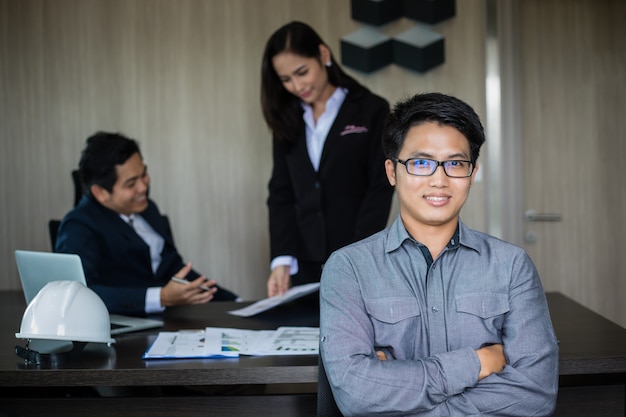 Asian business man and group using notebook for meeting and business men smiling happy for working