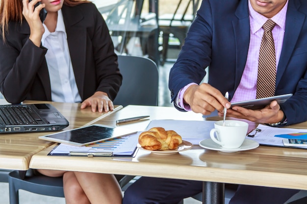 Asian business man and woman working in cafe