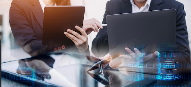 Asian business man and young beautiful woman working on digital tablet computer standing outside office building