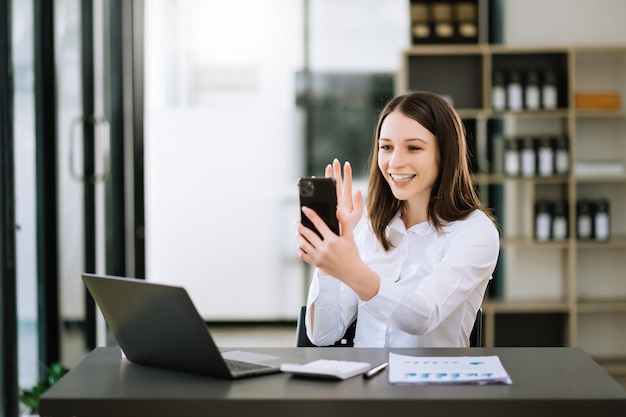 Asian business woman are delighted and happy with the work they do on their tablet laptop and taking notes at the officexA