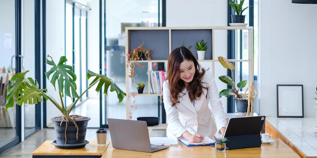 Asian business woman having video call with business team to consult about business plan of company Online team meeting video conference