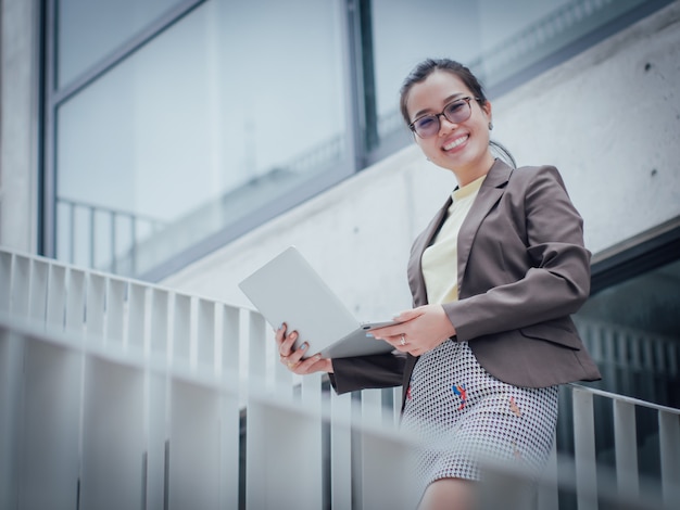 Asian business woman with laptop happy and smile concept success work 