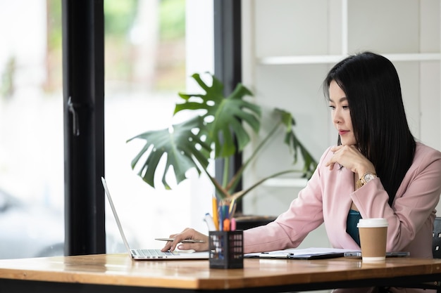 Asian business woman working notebook laptop in office Startup business asian woman small business employee freelance online working with computer laptop