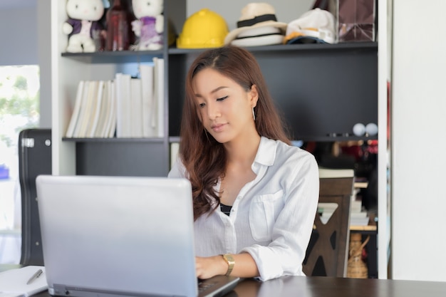 Asian business women using notebook and  smiling happy for working 