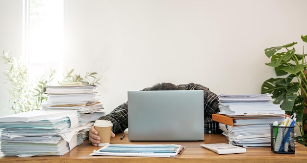 Asian businessman online working at home with a lot of document at home. Busy and exhausted.