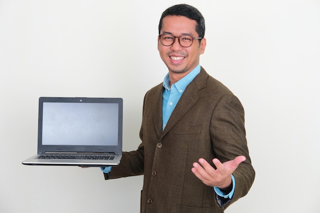 Asian businessman showing empty laptop screen with happy expression