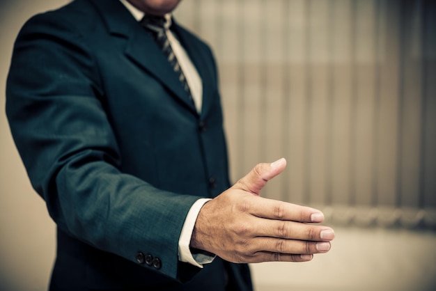 Asian businessman use right hand for to shake handthailand people