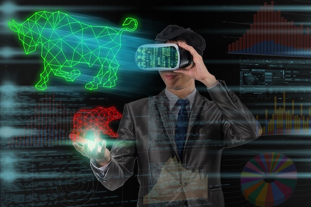 Asian Businessman using virtual reality glassed and hand holding Bull and Bear