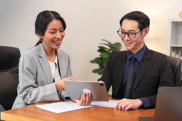 Asian businesspeople talk project strategy at office meeting room