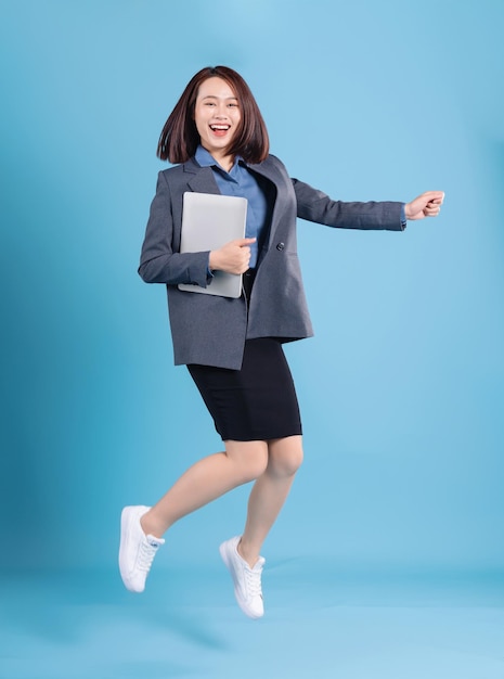 Asian businesswoman on blue background