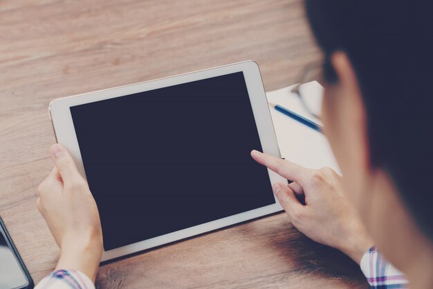 Asian businesswoman in the cafe and using tablet on table