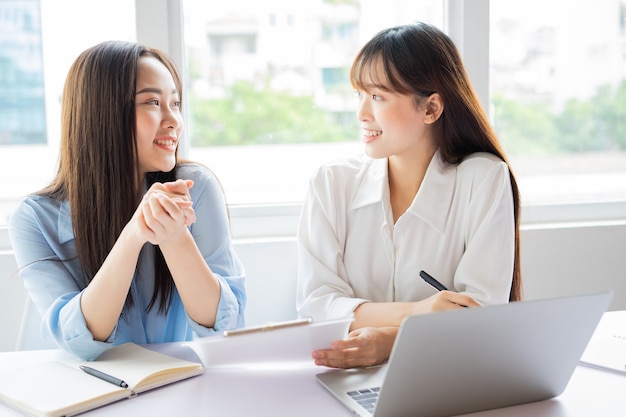 Asian businesswoman and colleagues discussing work together