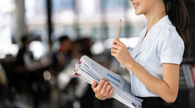 Asian businesswoman office workers holding arranging documents document management Businesswoman examining documents