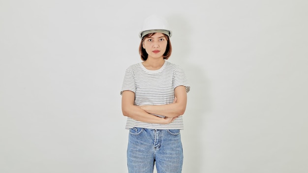 Asian businesswoman in a safety helmet and suit cross arms