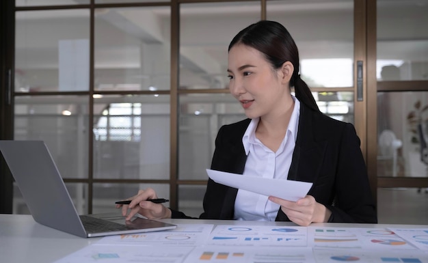 Asian businesswoman sitting work on a laptop at the office